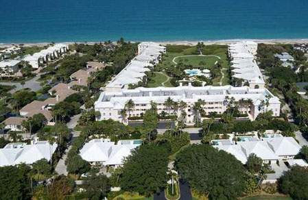 View of the property with the beach in the background